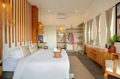 a bedroom with a large white bed in a room at 5 min walk to Seminyak Beach - Architect Designed Luxury Villa - Private Butler & Breakfast in Seminyak