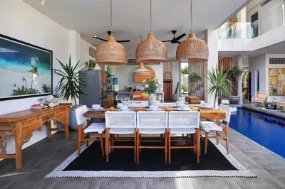 a dining room with a table and a pool at 5 min walk to Seminyak Beach - Architect Designed Luxury Villa - Private Butler & Breakfast in Seminyak