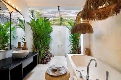 a bathroom with a tub and a sink and plants at 5BR Luxury Berawa Canggu with Butler in Canggu