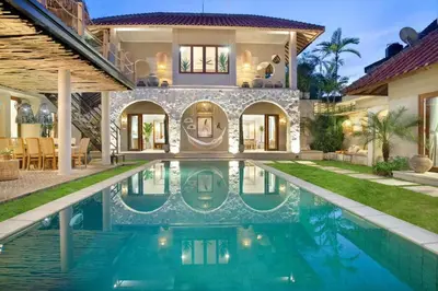 a house with a swimming pool in front of a house at 5BR Luxury Berawa Canggu with Butler in Canggu