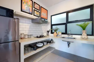 a kitchen with a stainless steel refrigerator and a sink at 1BR Villa Private Pool Seminyak Mertanadi in Seminyak