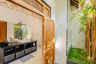 a bathroom with a sink and a mirror at 6BR Luxe Pool Villa Seminyak Group Escape in Seminyak