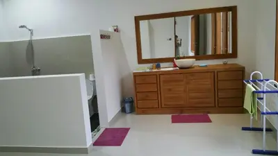 a bathroom with a sink and a large mirror at Elegant oasis between Canggu and Seminyak in Kerobokan