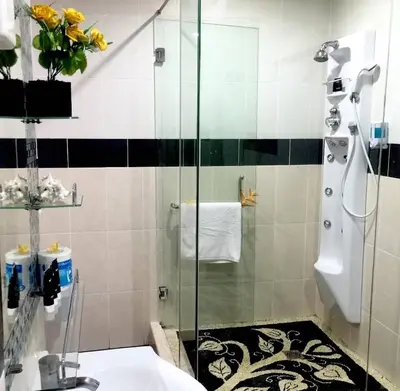 a bathroom with a shower and a sink at DBI Hotel - 1 minute to the Beach and 1 second to the Mall in Ngurah Rai International Airport