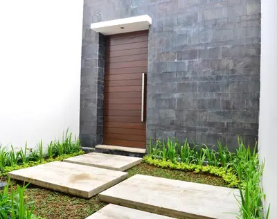 a front door of a house with a brick wall at Villa Tentrem Legian in Legian