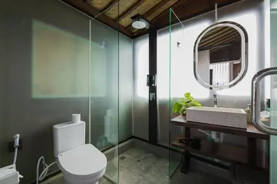 a bathroom with a toilet and a mirror at 1BR Japanese Inspired Bali Villa in Kerobokan in Kerobokan