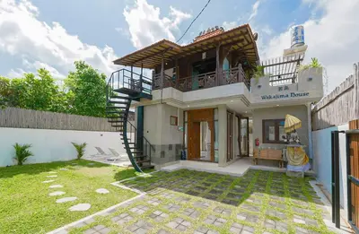 a house with a spiral staircase in a yard at 1BR Japanese Inspired Bali Villa in Kerobokan in Kerobokan