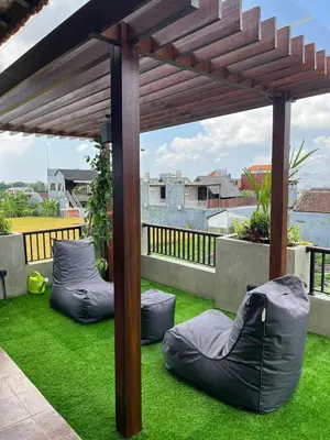 an outdoor patio with bean bags on the grass at 1BR Japanese Inspired Bali Villa in Kerobokan in Kerobokan