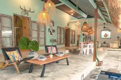 a living room with a wooden table and chairs at 2 BR Central Seminyak Villa Hibiscus Walk to shop and Beach in Seminyak