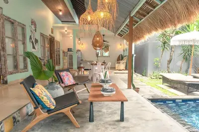 a living room with chairs and a table and a pool at 2 BR Central Seminyak Villa Hibiscus Walk to shop and Beach in Seminyak