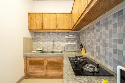 a kitchen with a stove and a sink at Q LE Villa 2 is 2BR Villa with Private Pool in Seminyak in Seminyak
