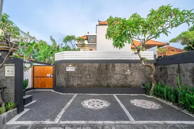 a courtyard with a stone wall and a house at Q LE Villa 2 is 2BR Villa with Private Pool in Seminyak in Seminyak