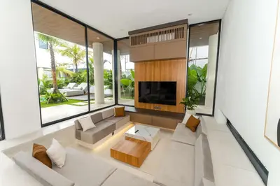 a living room with a couch and a tv at Luxury 4BR Villa - Pool Rooftop Berawa Canggu in Balian