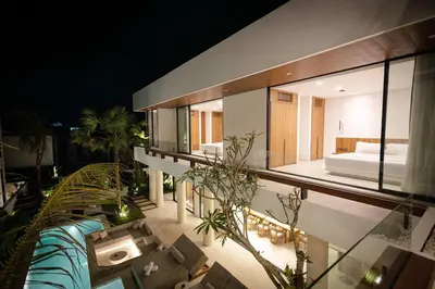 a large room with a bed and some plants at Luxury 4BR Villa - Pool Rooftop Berawa Canggu in Balian