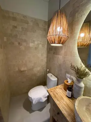 a bathroom with a toilet and a sink at Villa Makna Canggu in Canggu