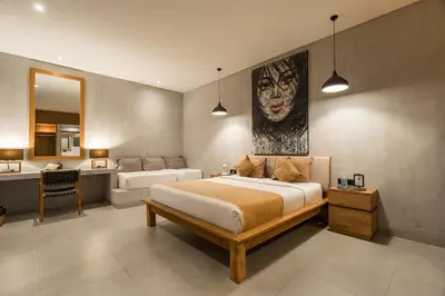 a bedroom with a large bed and a bathroom at Villa Kalooka by BaliSuperHost in Seminyak