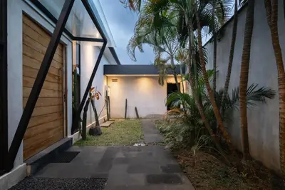 a hallway of a house with a palm tree at Villa Kalooka by BaliSuperHost in Seminyak