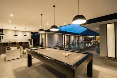 a pool table in the middle of a living room at Villa Kalooka by BaliSuperHost in Seminyak