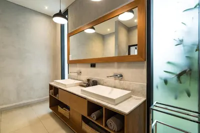 a bathroom with a sink and a mirror at Villa Kalooka by BaliSuperHost in Seminyak