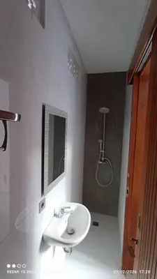 a white bathroom with a sink and a shower at Palm Harmony Villa's Seminyak in Seminyak