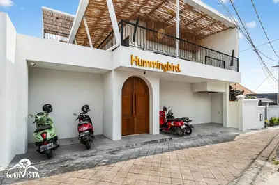 a couple of motorcycles parked outside of a building at Hummingbird Villa by Bukit Vista in Kerobokan