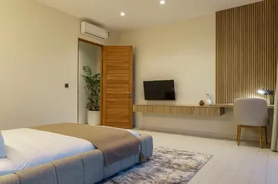 a bedroom with a bed and a flat screen tv at Private Romantic Pool 1bd Villa in Seminyak in Seminyak