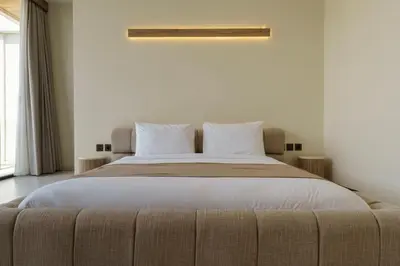 a bedroom with a large bed with white sheets and pillows at Private Romantic Pool 1bd Villa in Seminyak in Seminyak