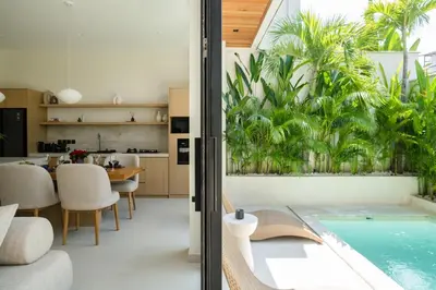 an open kitchen and dining room with a swimming pool in a house at Private Romantic Pool 1bd Villa in Seminyak in Seminyak