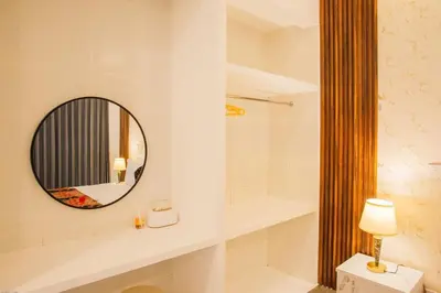 a bathroom with a mirror and a shower at Ratu Guest House in Mantaak