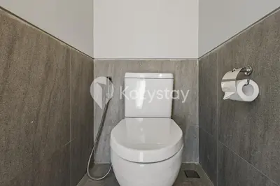 a bathroom with a white toilet with a hose at Niskala Villa by Kozystay - Natadesa Resort in Jimbaran