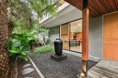 a large black vase sitting in the middle of a garden at Niskala Villa by Kozystay - Natadesa Resort in Jimbaran