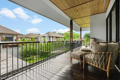 a balcony with a view of a house at Niskala Villa by Kozystay - Natadesa Resort in Jimbaran