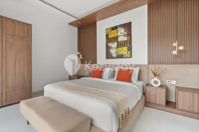 a bedroom with a large white bed with orange pillows at Biyan Villa by Kozystay - Seminyak in Seminyak