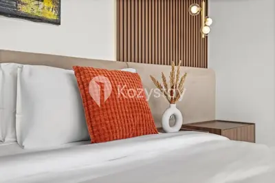 a bed with a red pillow sitting on top of it at Biyan Villa by Kozystay - Seminyak in Seminyak