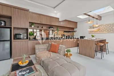 a living room with a couch and a kitchen at Biyan Villa by Kozystay - Seminyak in Seminyak