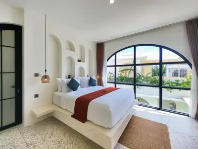 a bedroom with a large bed and a large window at Villa Emilia Canggu by Nagisa Bali in Canggu