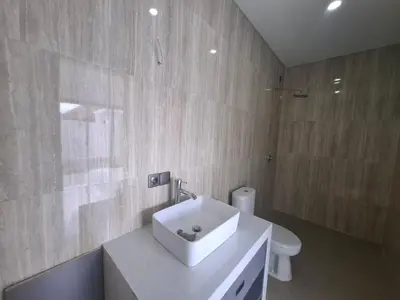 a bathroom with a white sink and a toilet at Villa umalas in Seminyak