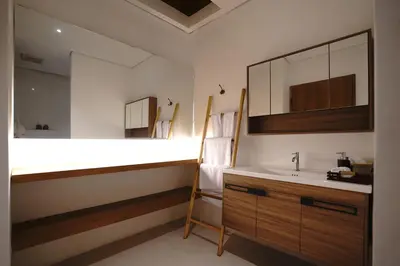 a bathroom with a sink and a mirror at Juan Villa Legian in Seminyak