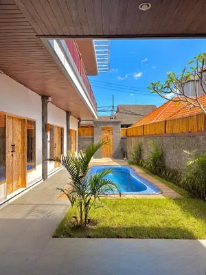 an external view of a house with a swimming pool at Tanhana Seminyak in Kerobokan