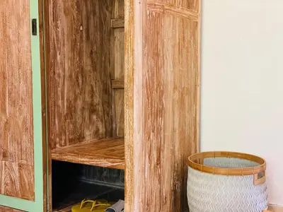 a wooden cabinet with a bucket in a room at Superb Location! Modern 2BR Seminyak Oasis with Pool & Garden in Seminyak
