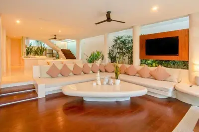 a living room with a white couch and a table at Yelena Spacious 3 BR Private Pool Villa in Canggu
