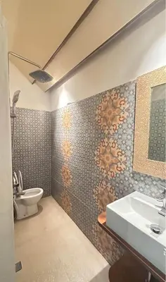 a bathroom with a sink and a toilet at Authentic Balinese Riverside Villa in Kerobokan