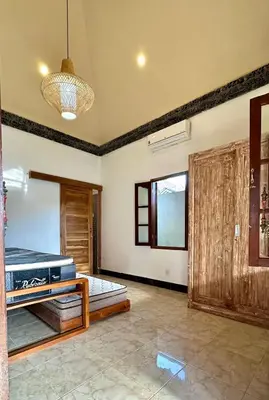 a large room with a bed and a window at Authentic Balinese Riverside Villa in Kerobokan