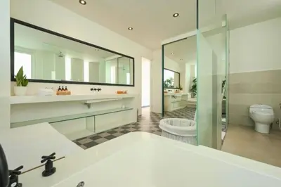 a large bathroom with a tub and a toilet at Yahira Stunning Garden 5 BR Private Pool Villa in Canggu