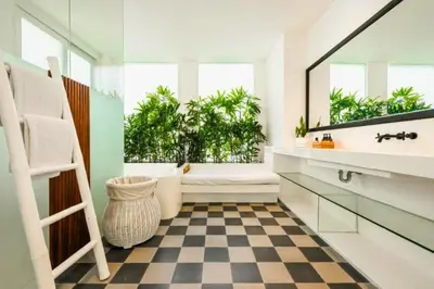 a bathroom with a sink and a toilet and a mirror at Yahira Stunning Garden 5 BR Private Pool Villa in Canggu