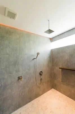 a shower in a bathroom with a wall at 2 Bedroom Seminyak Apartment -1 in Seminyak