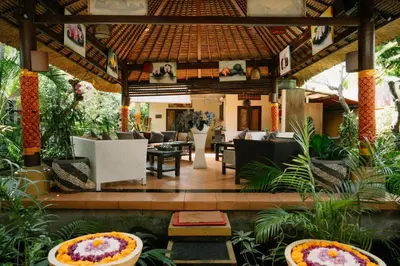 a lobby of a resort with tables and chairs at Bali Orchid Spa in Kuta