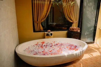 a bath tub filled with sprinkles in a bathroom at Bali Orchid Spa in Kuta