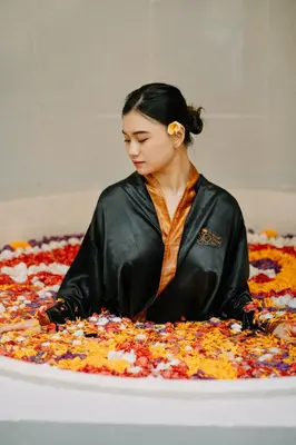 a woman is sitting on top of a pizza at Bali Orchid Spa in Kuta
