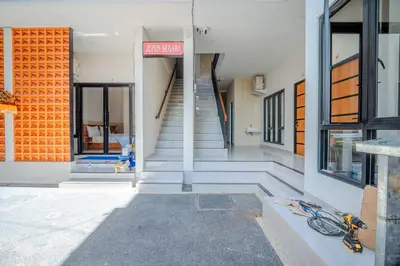 a group of stairs leading to a building at Wana Kubu Suite and Dormitory in Ngurah Rai International Airport